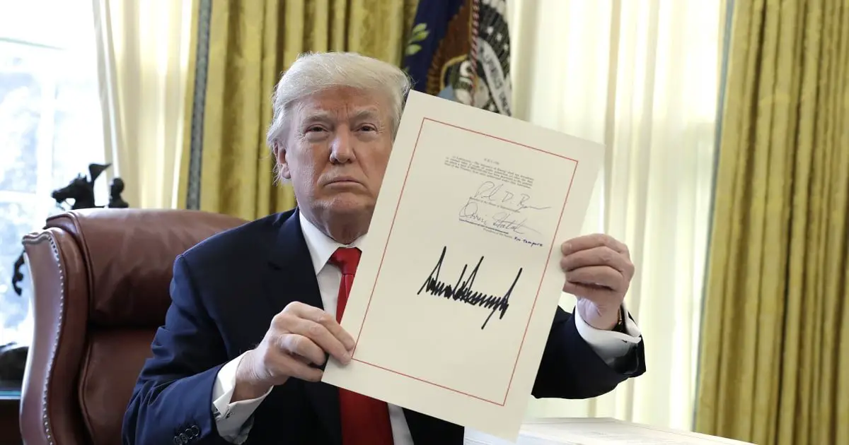 Trump signs tax cut bill, first big legislative win
